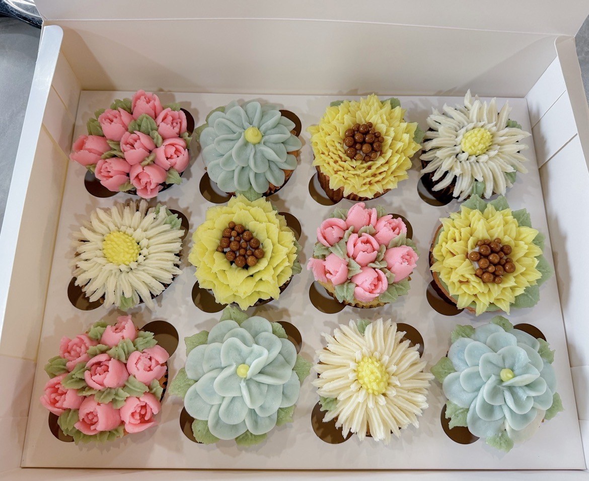 Floral decorated cupcakes in a box